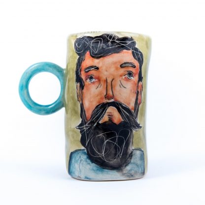 bearded man portrayed on handmade pottery cup