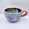 XL handmade ceramic cup with hand painted cartoon named Miss Art and colorful painting inside.