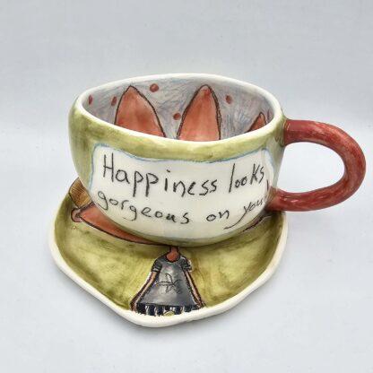 Stoneware tea cup with handle and saucer