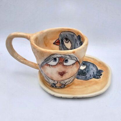 Ceramic art on stoneware espresso cup with handle and saucer