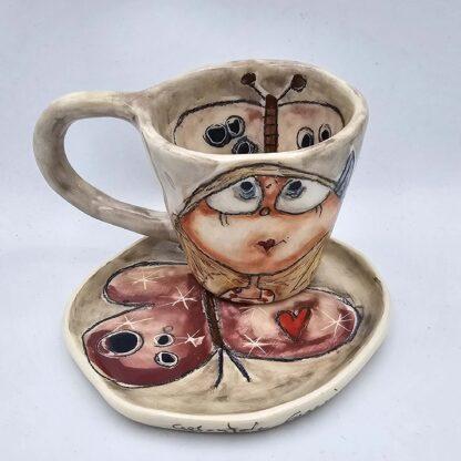 Ceramic art on stoneware espresso cup with handle and saucer