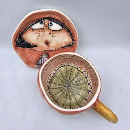 Cute ceramic tea cup with handle and saucer