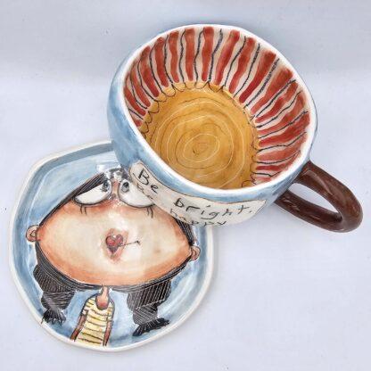 Cute ceramic tea cup with handle and saucer