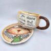 Unique pottery tea cup with handle and saucer