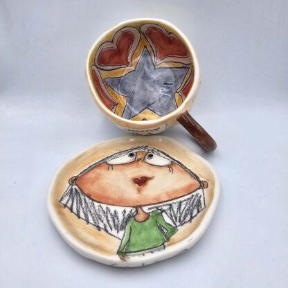 Unique pottery tea cup with handle and saucer