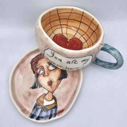 Unique pottery tea cup with handle and saucer