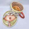 Unique stoneware tea cup with handle and saucer