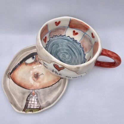 Unique stoneware tea cup with handle and saucer