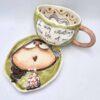 Pottery tea cup with handle and saucer