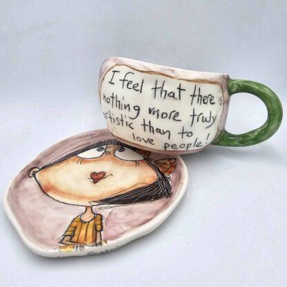 Pottery tea cup with handle and saucer