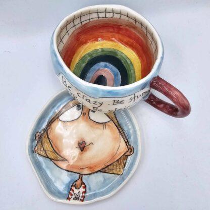 Pottery tea cup with handle and saucer