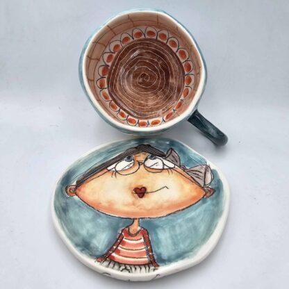 Ceramic tea cup with handle and saucer