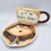 Stoneware tea cup with handle and saucer