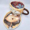 Stoneware tea cup with handle and saucer