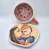 Stoneware tea cup with handle and saucer