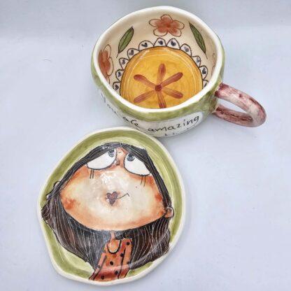Cute stoneware tea cup with handle and saucer