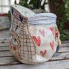 Unique pottery cup shaped as a gunny / burlap sack
